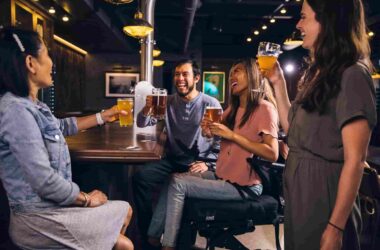 Unique uses of beermats; a group of people laughing and enjoying their beers