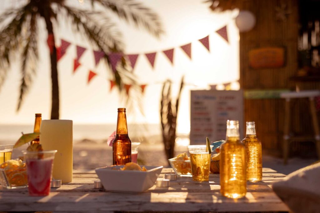 cheap pub beer mats, beer and food spread on table by beach