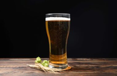 beer mat collection, glass of beer on beer mat on wooden table