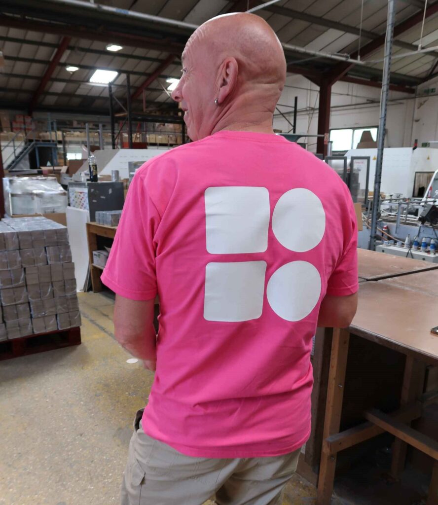 work uniform logo, Mosaic BoardPrint employee in pink t-shirt