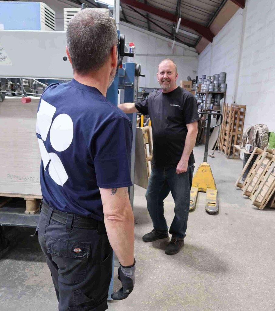 company uniform policy, two Mosaic BoardPrint employees looking at each other